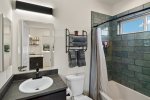 The casita has a private bathroom with a modern bath/shower combo